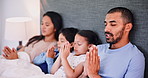 Family in bed, praying and worship for religion, peace and bonding together at home with love and trust. Gratitude, faith and talking with God, parents and children in bedroom with people and prayer