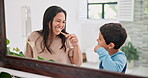 Mother, child and brushing teeth in bathroom with mirror, morning routine and dental with toothpaste for fresh breathe. Health, self care with woman and boy bonding for oral hygiene at family home