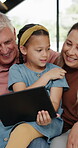 Closeup, girl or family on tablet as fun, digital or tech as internet, media or gaming on sofa. Grandpa, grandma or child on touch screen for web, learning or search as bonding together in home