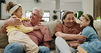 Grandfather, grandmother and children in lounge, happy and excited for bonding on couch. Young girls, man and woman with smile in family home to relax, laugh and enjoy on sofa in living room