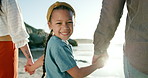 Parents, child and happy face for holding hands on beach, sunset and love with bonding on summer holiday. Father, mother and daughter in portrait on sea sand, blue sky and relax in nature on vacation