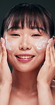 Studio, skincare and portrait of woman with creme, beauty and face clean for natural lotion. Asian girl, smile and happiness for treatment on skin for ant ageing with results from dermatology