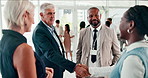 Business people, handshake and meeting in conference, networking and discussion at global convention. Professionals, collaboration and introduction or greeting at seminar, welcome and thank you