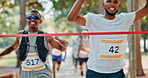 Fitness, celebration or sports runner at the finish line with arms raised for victory, achievement or exercise goals. Winning event, fast or happy man excited by running, marathon training or workout