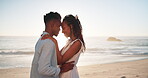 Couple, romance and talking with sunrise at beach for affection, commitment and bonding on honeymoon vacation. Black man, woman and happy by ocean for anniversary date, relax and lens flare in nature