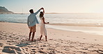 Happy, dance and couple at sunset on beach together for bonding, relax and happy relationship. Dating, travel and man and woman dancing by ocean for romantic holiday, vacation and weekend in nature