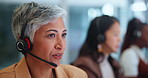 Senior woman, consulting and call center with headphones in customer service or support at office. Mature female person, consultant or agent talking for online advice, assistance or help at workplace