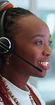 Black woman, face and consultant with headphones at call center for customer service at office. Closeup of African female person or agent with smile and talking for online advice or help at workplace