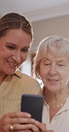 Phone, conversation and woman with elderly mom helping on social media, app or internet. Discussion, technology and female person talking, bonding and explaining cellphone to senior mother at home.