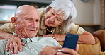 Home, help and old couple with a smartphone, conversation or relax with internet or mobile user. Apartment, senior woman teaching elderly man or cellphone with social media or typing with digital app