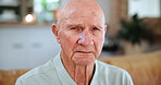 Mental health, senior man and mourning while sad, indoor and depressed in house, lounge and living room. Elderly man, closeup and widower with sorrow, despair or lonely on a couch, sofa or retirement