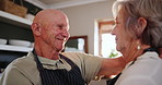 Senior, happy couple and hug with love in kitchen for support, trust or romance together at home. Elderly man and woman with smile or apron for morning, embrace or bonding in relationship at house