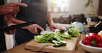 Couple, hands and cutting vegetables with tablet for online tutorial, recipe or list of ingredients in kitchen at home. Closeup of people with technology, natural or organic food for cooking at house