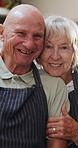 Happy, face and senior couple in kitchen hug with love, support and care in marriage or retirement. Elderly, man and woman embrace with kindness and gratitude for cooking dinner in home together