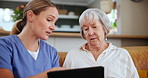 Medical, tablet and nurse planning with old woman on sofa in living room of home for consulting or help. Healthcare, trust or tech with and caregiver with senior patient talking about assisted