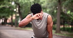 Exhausted, sweat and portrait of man with break for fitness training, exercise and morning cardio. Tired, male athlete and hand with face wipe for rest, running pause and workout fatigue in nature