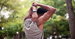 Back view, nature or runner stretching arms for fitness training, wellness or exercise outdoors in park. Sports person, muscle flexibility or healthy male athlete in warm up to start running workout