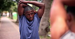 Nature, fitness and black man stretching arms for exercise in outdoor park, field or garden. Sports, health and African male athlete with muscle warm up workout for training with personal trainer.