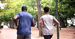 Fitness, running and man with personal trainer in park for outdoor morning workout in woods. Health, wellness and friends in nature together for muscle exercise, marathon and men training from back.