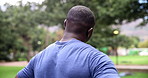 Fitness, neck stretching and black man in park for outdoor morning workout in garden from back. Health, wellness and trees with athlete in nature for warm up, exercise and training challenge for body