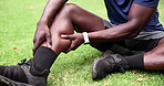 Sports, fields and legs of person with injury, muscle strain and accident for training, workout or practice. Fitness, health and athlete with inflammation, medical emergency and pain for exercise