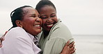 Happy, mother and daughter hug at beach with love and happiness on holiday or travel on vacation together. African, family and black woman embrace mature mom at ocean or sea with kindness and support