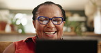 Glasses, tablet and senior black woman on a sofa reading ebook, social media or funny gif at home. Digital, app and face of old African person with online comic, show or movie and chill in a house