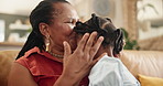 Grandmother, child and forehead kiss for love in home, affection and bonding or care in living room. Black family, grandkid and grandma on couch and happy on weekend, comfort and smile in lounge