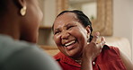 Senior mom, black woman and happy on sofa with embrace, connection and laugh for bonding in home. Family, mature mother and daughter on couch with funny story, joke and love in living room at house
