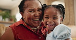 Face, smile and child with grandmother on sofa bonding together in living room at modern home. Happy, love and portrait of African senior grandma relaxing and holding girl kid at modern family house.