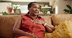 Mature African woman, thinking and home on sofa with ideas, memory or relax in living room in Kenya. Senior person, vision and remember on lounge couch with nostalgia, choice or decision in apartment