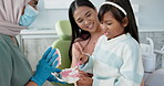 Child, pediatric dentist or teach on brushing teeth in practice or kid friendly demonstration of tooth hygiene. Orthodontist, parent or girl by dental model or cleaning mouth in interactive education