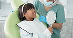 Dentist, woman and kid with mirror for dental health, results and teeth cleaning service with medical advice or support. Orthodontist or doctor talking to child or excited girl of tooth procedure