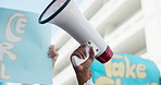 Activism, sign and hand with megaphone at march for equality, justice and community freedom. Poster, closeup and person with banner, speaker or bullhorn for political protest, rally or strike.