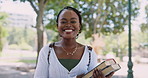 Student, smile and face of black woman with books in outdoor park at university for studying. Happy, education and portrait of confident young African female person in field at college campus.