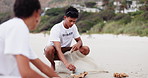 People, volunteer and cleaning beach with recycling plastic, bottles and bags for community service. Volunteering workers or person collecting rubbish, dirt or garbage to save the earth, sea or ocean