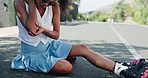 Rollerblade, accident and woman with outdoor pain, blood and injury for mistake, adventure or risk on asphalt road. Young person, gen z or skater with hurt elbow, scratch and wound in city or street