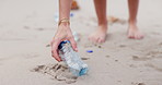 People, hands and beach with bag for recycling plastic bottle, cleaning or saving the planet in nature. Closeup of volunteer picking up rubbish, dirt or garbage of waste on sandy shore or ocean coast