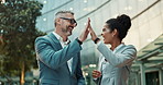 Business people, high five and city building or teamwork celebration with tablet for email achievement, collaboration or support. Man, woman and laugh in downtown New York for winner, goal or startup