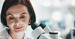 Scientist, woman and microscope at laboratory with sample for analysis of bacteria, particles or test for research. Person, science and study to check results for medical innovation at pharma company