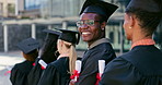 Smile, graduation and face of black man with students at university in line with diploma, degree or scroll. Happy, education and portrait of African person waiting with college certificate at school.