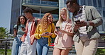 Friends, students and phone for texting at college, mobile app and share with post, meme or web blog. Gen z group, man and woman with smartphone, social media and funny chat at university in Atlanta