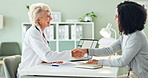 Woman, doctor and patient with handshake for thank you, meeting or consultation at the hospital. Female person, cardiologist and client shaking hands for agreement, visit or prescription at clinic