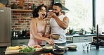 Happy, feeding and couple with fruit salad in kitchen for healthy, nutrition or diet breakfast. Smile, love and young man and woman eating smoothie bowls together for wellness snack in apartment.