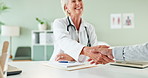 Senior woman, doctor and handshake with patient for prescription, thank you or meeting at clinic. Happy female person, cardiologist or medical employee shaking hands with client for consultation