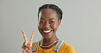 Smile, peace sign and woman blowing a kiss in studio isolated on a gray background mockup space. Portrait, love and v hand gesture of African person with emoji, symbol and show happy face expression