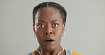 Face, surprise and black woman with omg, announcement and fake news on a grey studio background. Portrait, African person and model with reaction to a secret and gossip with emoji, wtf and shocked