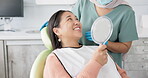 Dentist, woman patient and mirror for dental care, teeth and smile at consultation. Medical, healthcare and orthodontist in clinic, oral hygiene examination and happy female person at checkup