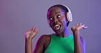 Woman, headphones and dancing to music in studio or glitter cosmetics or neon light, purple background or listening. Black person, happy and streaming entertainment for audio, stress relief or mockup