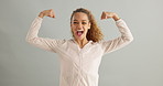 Happy, face and woman with arm flex in studio for success, celebration or victory on grey background. Excited, portrait and female model with power pose for empowered, accomplishment or fist emoji